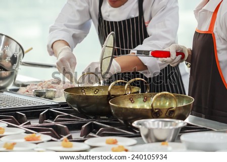 Busy cooking of chefs in restaurant kitchen