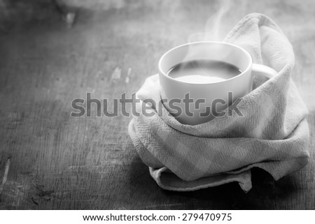 Cup of hot coffee with steam on black and white. Monochrome image.