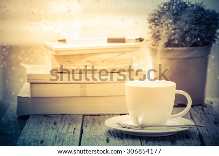 Coffee cup on a rainy day window background