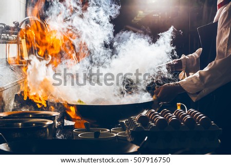 Fire burn is cooking on iron pan,stir fire very hot