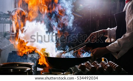 Fire burn is cooking on iron pan,stir fire very hot