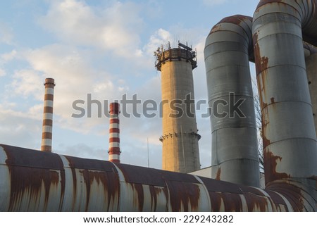 factory pipes and blue sky at sunset