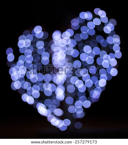 blur light shape heart. blue heart on black background.