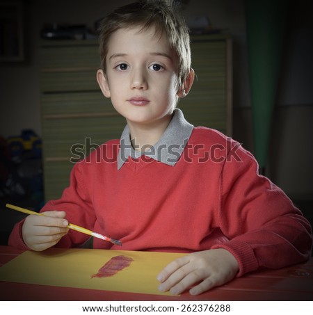 little boy doing homework painting, early education