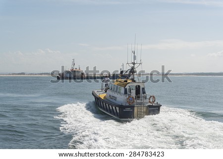 Figueira Da Foz, Portugal - September 20, 2014: pilot boat in embarkation position in the port of the Figueira Da Foz.