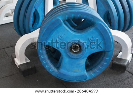 weight lifter weights in a gym hall. fitness theme.