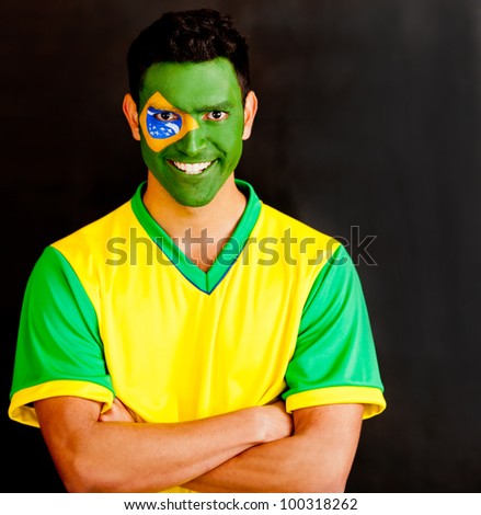 Confident Brazilian man with arms crossed and painted face