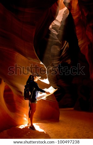 Female explorer inside a cave at the Grand Canyon