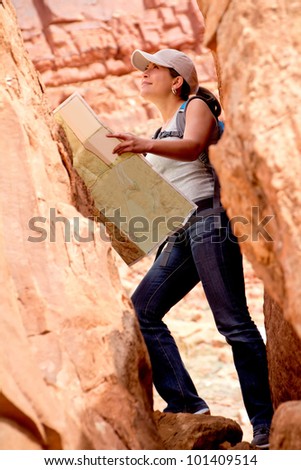 Adventurous woman exploring the desert holding a map