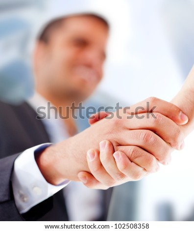Business man closing a deal with a handshake