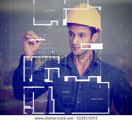 Construction worker wearing a helmet and sketching blueprints