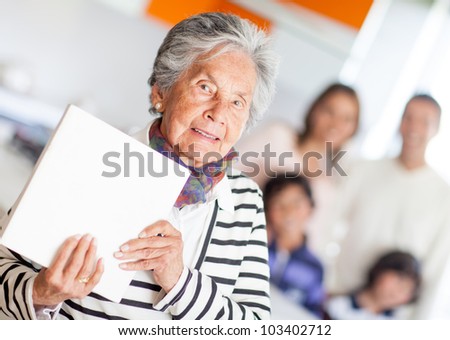 Grandma holding a book of cooking recipes