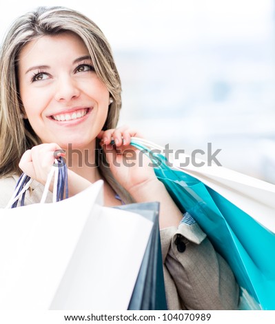 Beautiful shopping woman holding bags and smiling