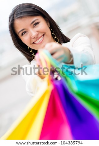 Happy female shopper holding shopping bags