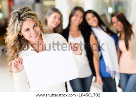 Beautiful woman holding banner with a group of girls behind