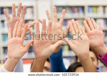 Students raising their hand wanting to participate in class
