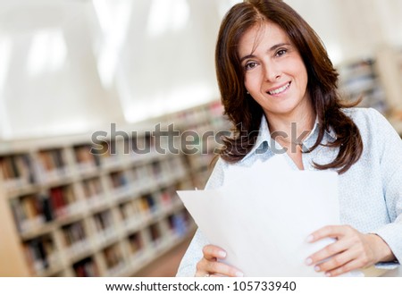 Female librarian organizing documents at the library