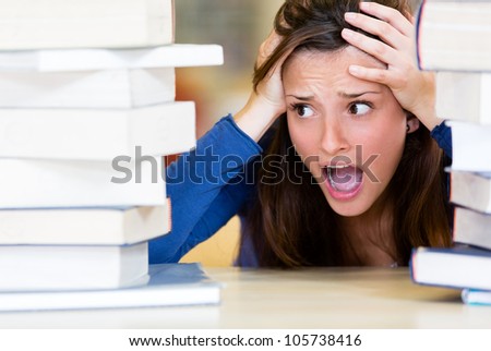 Worried female student with a lot of work to do