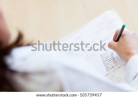 Teacher with attendance list ticking names of students
