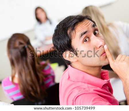 Male student asking for silence in the classroom