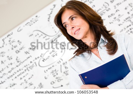 Post-graduate engineering student with a whiteboard full of formulas