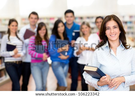 Female teacher smiling with a group of university students