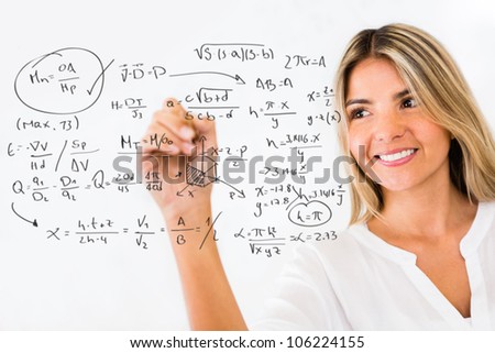 Female student writing math formulas and smiling