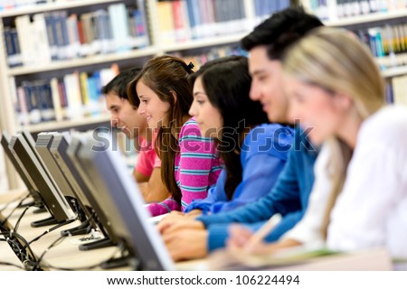 Group of students using computers at the library
