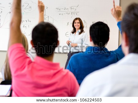 Students in class asking questions to the teacher