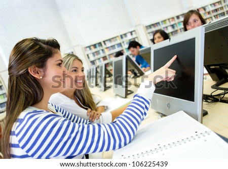 Women studying together on a computer lab