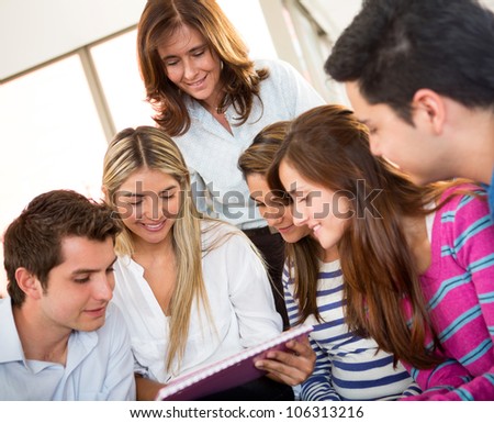 Group of young people studying and looking at notes