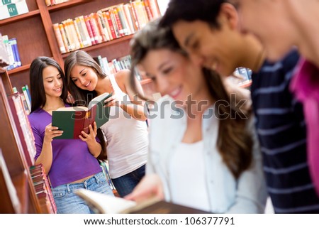 Group of students researching at the library and reading books