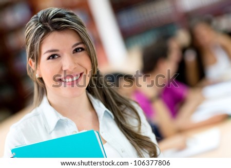 Beautiful portrait of a female student holding a notebook