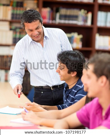 Male teacher explaining a subject to his students in class