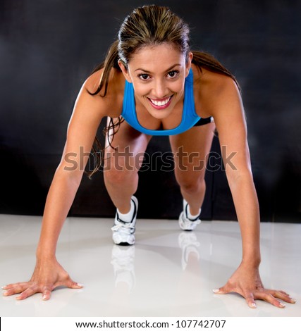 Female athlete in a position ready to run