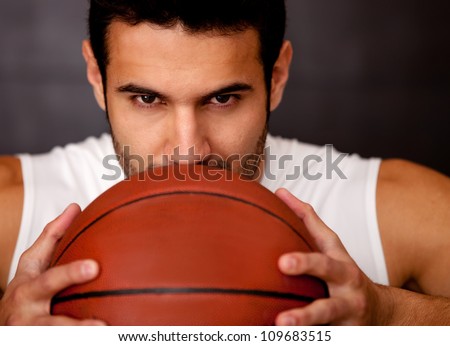 Aggressive male basketball player holding the ball