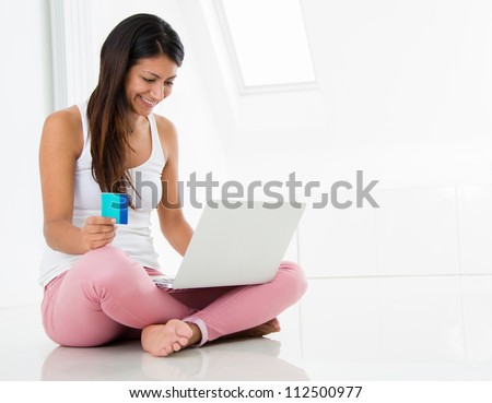 Happy woman shopping online with a credit card
