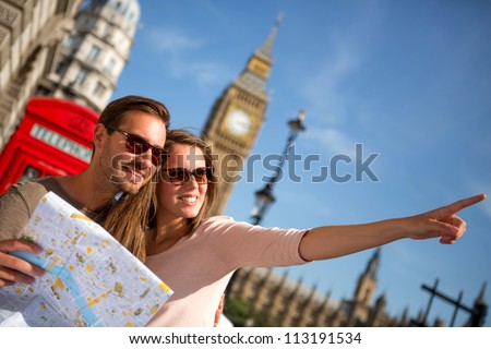 Couple Of Tourists In London Holding A Map