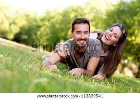 Couple outdoors enjoying a summery day looking happy