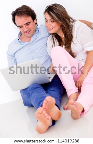 Couple at home working on a laptop computer