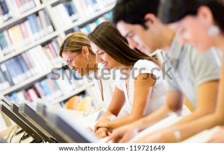 Group of students researching at the library on computers