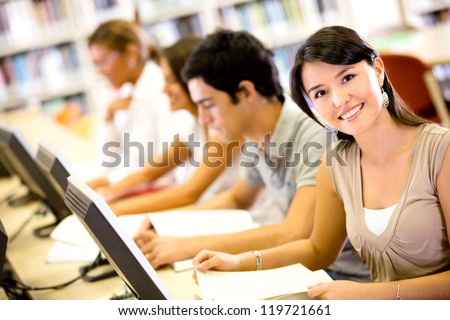 Group of people researching at the library on computers