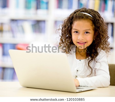 Girl using a laptop computer at school Girl using a laptop computer at school