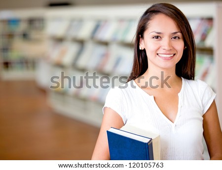 Female student at the library looking happy Female student at the library looking happy