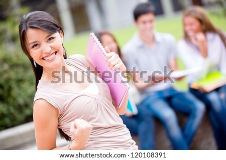Excited female student celebrating an achievement looking happy