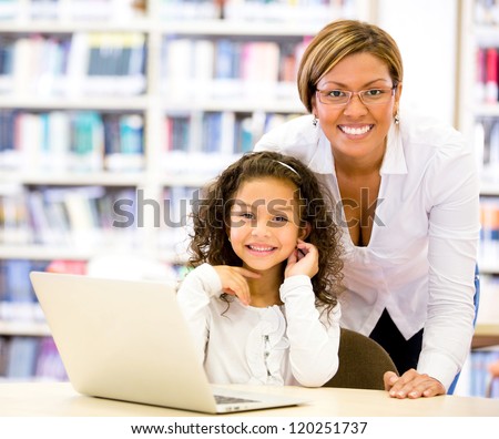Girl with a computers teacher looking very happy