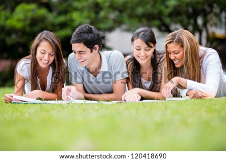 Group Of Students Outdoors Studying And Looking Happy