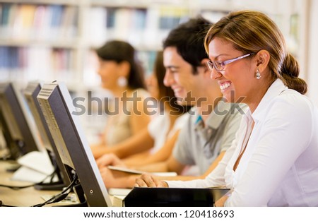 Students researching online at the library on computers