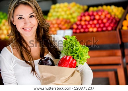 Happy woman at the local market buying groceries