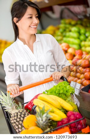 Female customer at the supermarket with a shopping cart